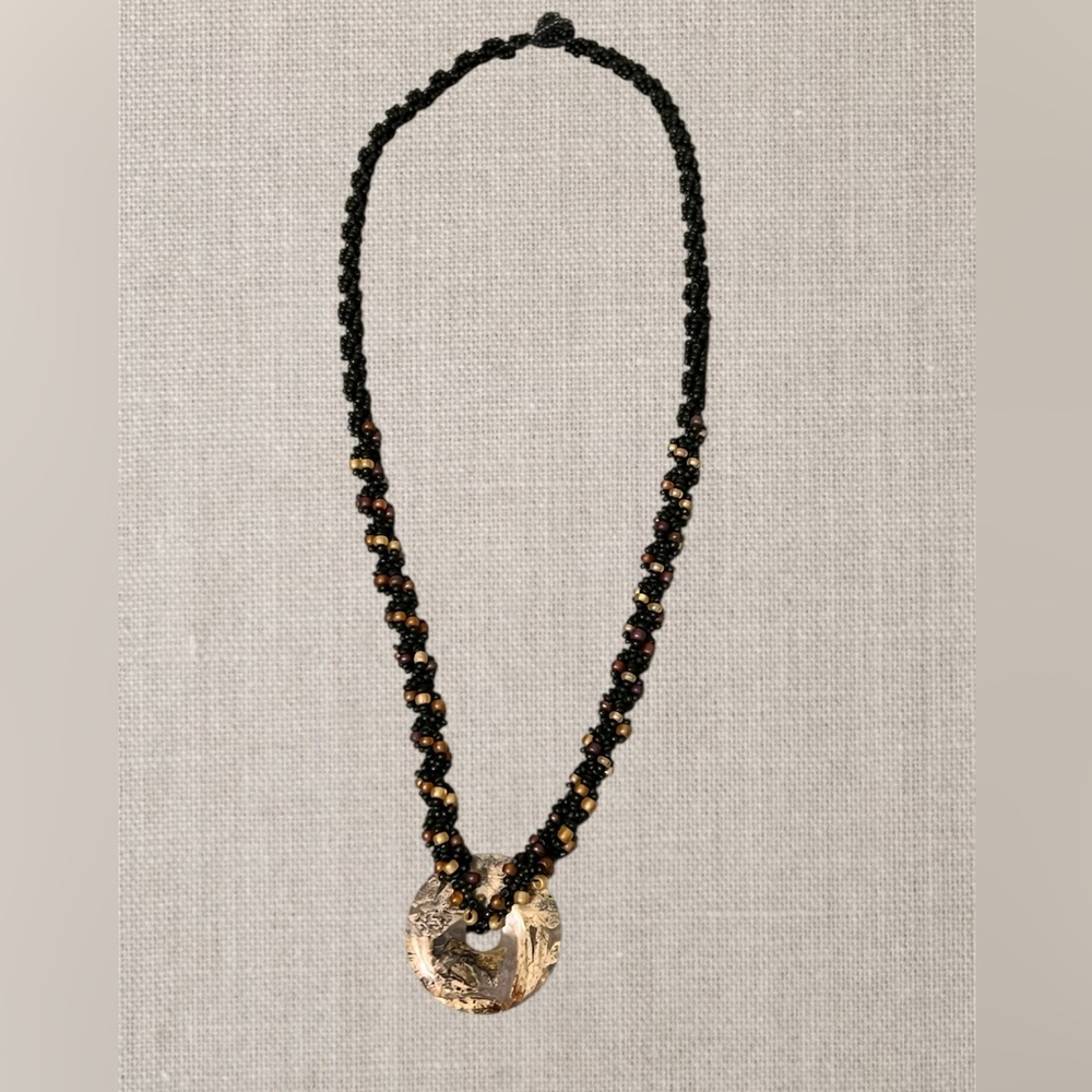 Twisted beaded necklace of black & multi-colored glass seed beads, agate pendant